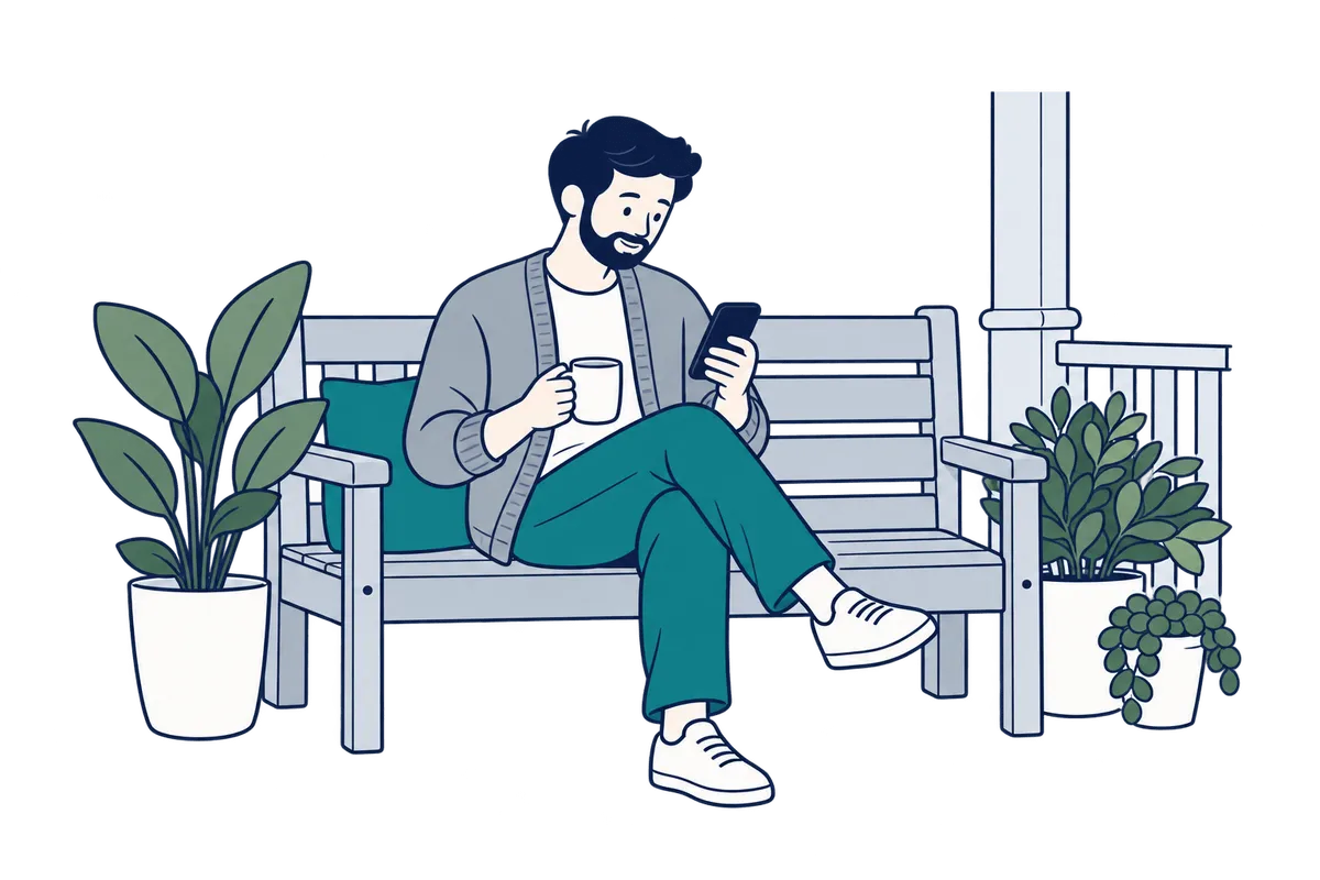A man on a garden bench at home, messaging work on his phone