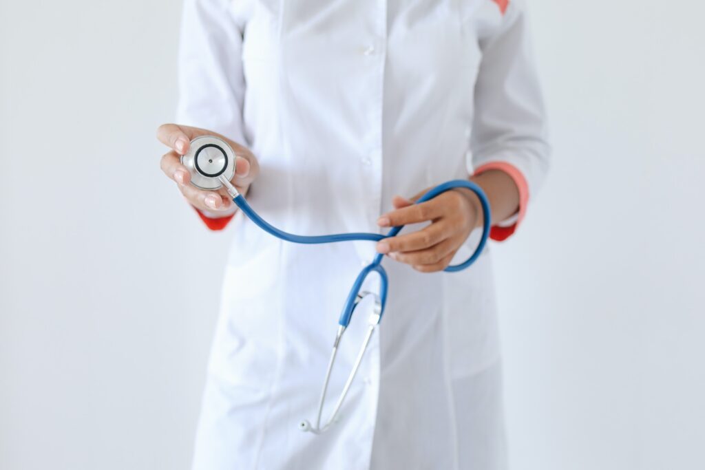 doctor holding a blue stethoscope